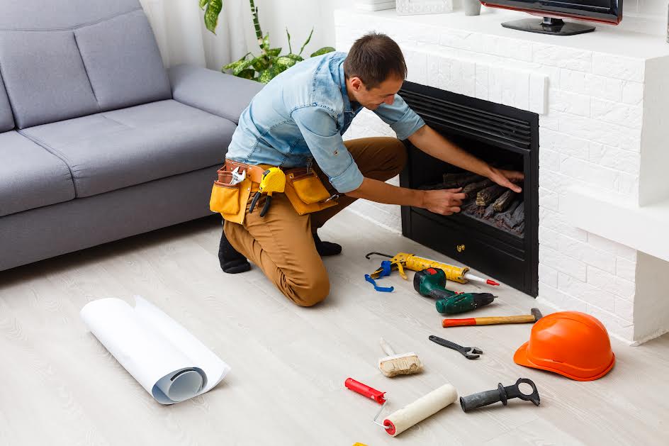 Man fixing electric fireplace